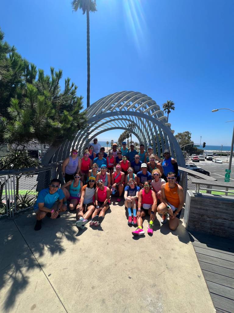 Group of runners poses during a run in Santa Monica. 