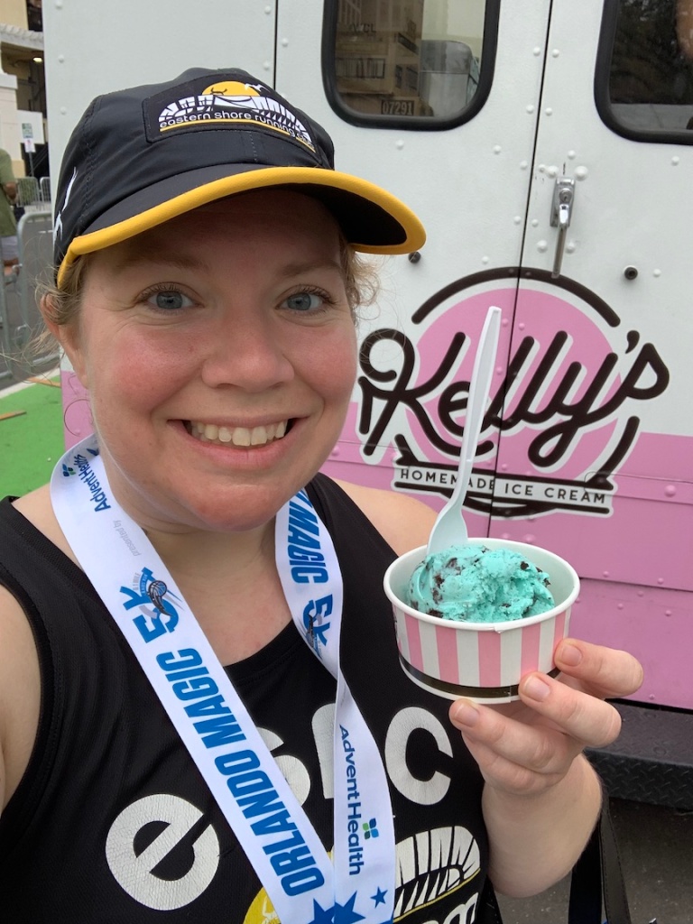 Vanessa Junkin takes a selfie with a cup of ice cream from Kelly's Homemade Ice Cream, with the truck in the background. 