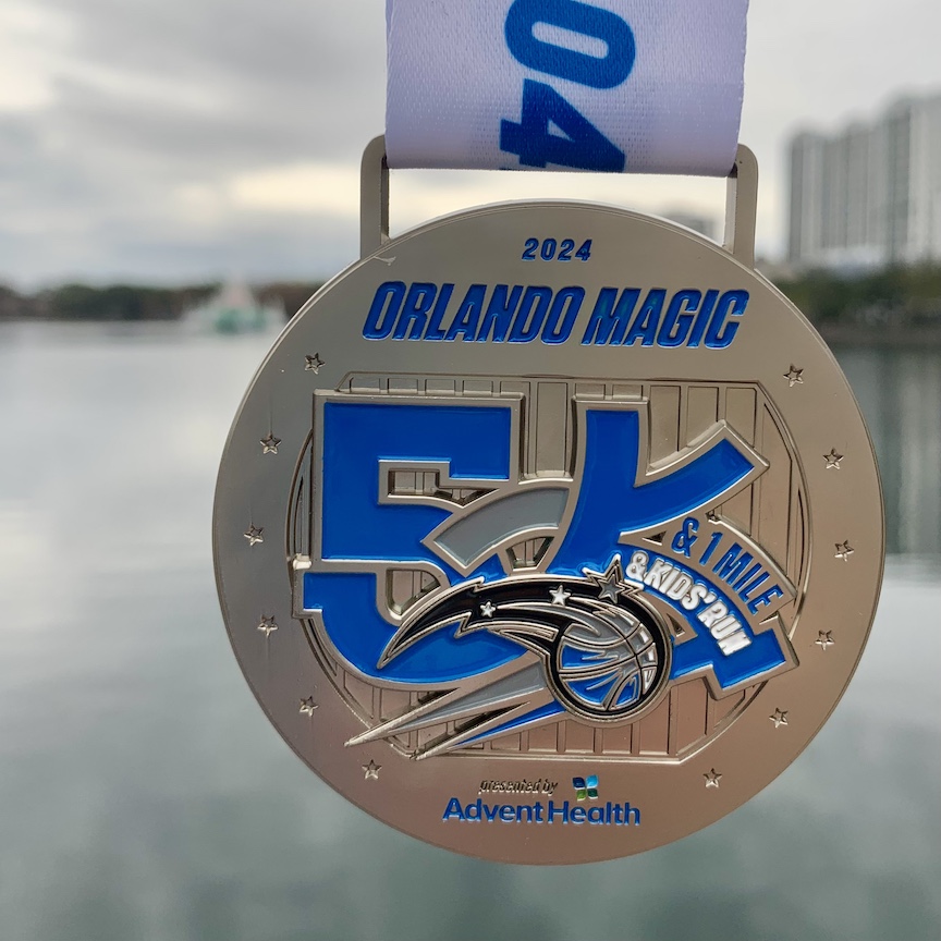 Finisher medal for the Orlando Magic 5K with Lake Eola in the background. 