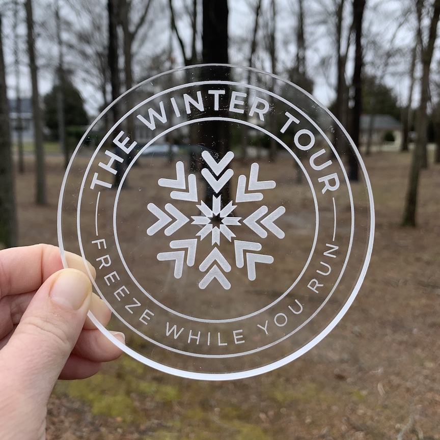 The Winter Tour finisher snowflake is shown with trees in the background. 